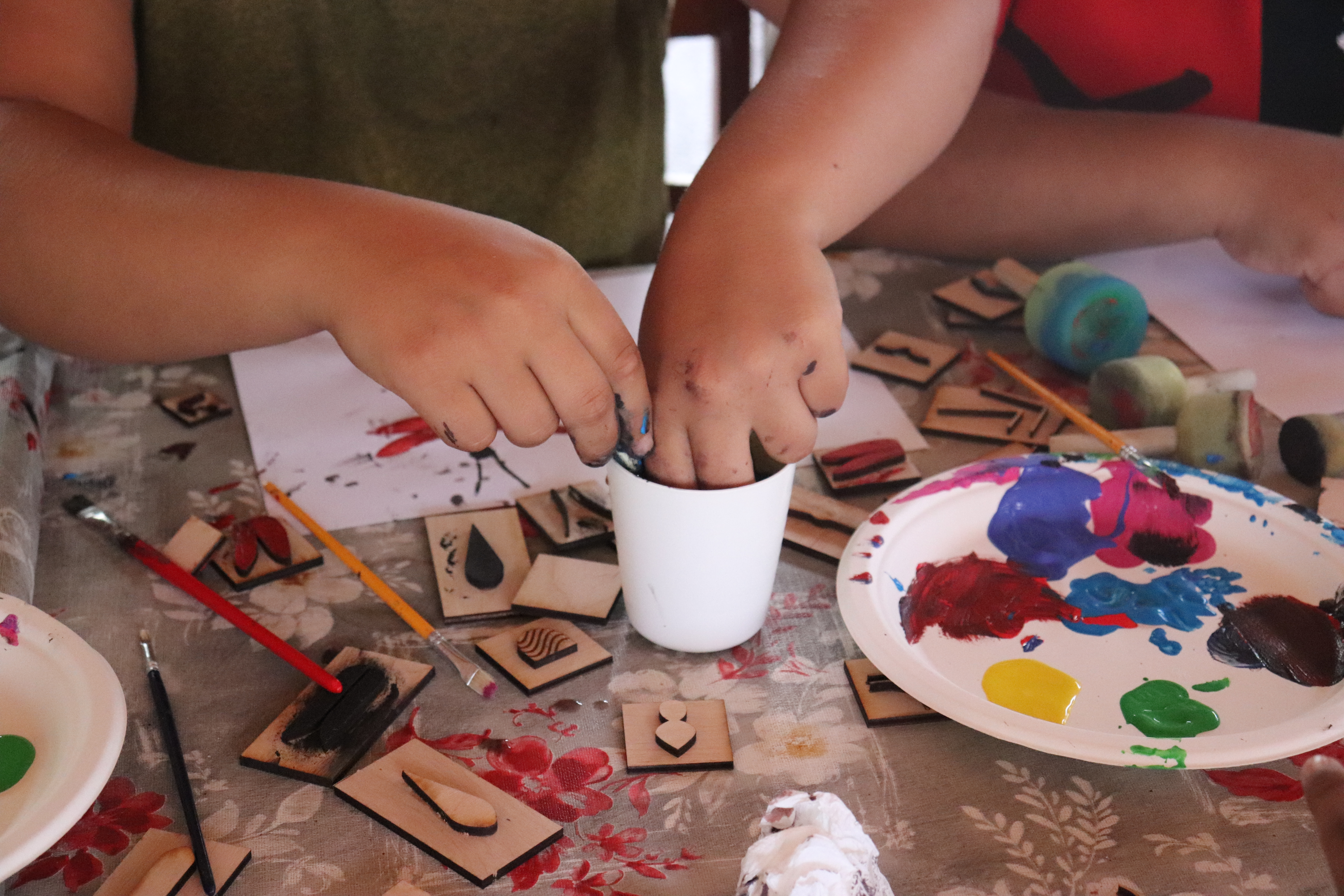 Childrens hands with 2D bug stamps